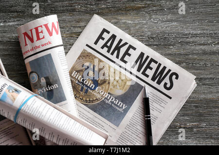 Morning newspapers on wooden background Stock Photo