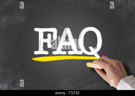 term FAQ, frequently asked questions, written on blackboard Stock Photo