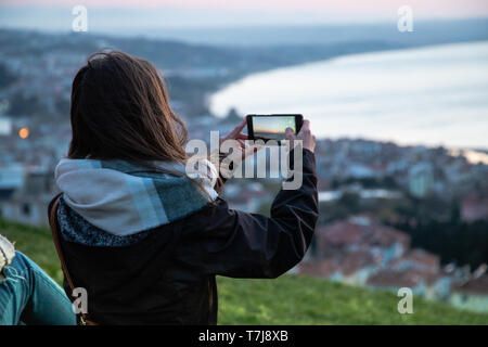 Girl taking photo in sinop sunset in turkey Stock Photo