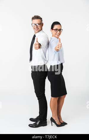 Full length of a colleagues couple wearing formal clothing standing isolated over white background, thumbs up Stock Photo