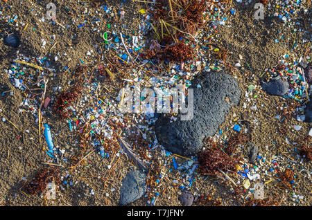 Micro plastics mixed in the sand in Famara beach, Lanzarote Stock Photo