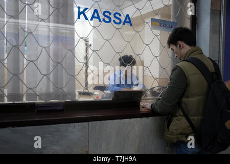Man buying tickets at the Alisher Navoi Station of the Tashkent underground Metro in Uzbekistan Stock Photo