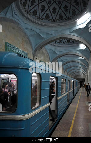 Commuters at Alisher Navoi Station of the Tashkent underground Metro in Uzbekistan. The Tashkent Metro built in the former USSR is one of only two subway systems currently operating in Central Asia and its stations are among the most ornate in the world. Stock Photo