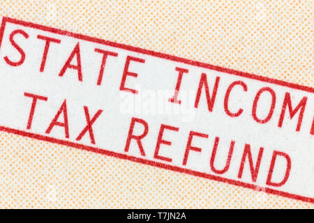 Macro detail of state income tax refund check paper statement text. Stock Photo
