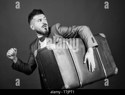 Thief run away with heavy suitcase. Theft of century. Delivery service. Travel and baggage concept. Hipster traveler with baggage. Baggage insurance. Man well groomed bearded hipster big suitcase. Stock Photo