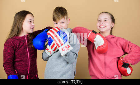 punching knockout. Childhood activity. Sport success. Team fight. workout of small girls and boy boxer in sportswear. Happy children in boxing gloves. Fitness diet. energy health. Resting time. Stock Photo