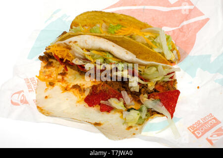 2 Taco Bell tacos on wrapper, 1 Crunchy Taco hard shell and 1 Loaded Nacho Taco spicy soft shell on wrapper Stock Photo