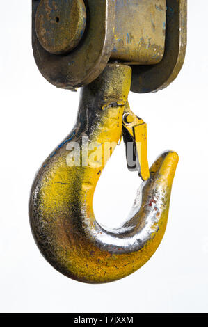 Closeup of a industrial yellow lifting crane hook on a white background. Stock Photo