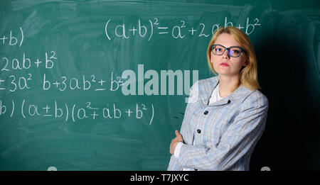 woman in classroom. teacher on school lesson at blackboard. Back to school. Teachers day. Study and education. Modern school. Knowledge day. Confident in their successful future. serious woman. Stock Photo