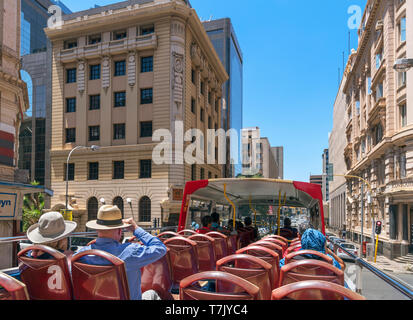 Tourists on a City Sightseeing tour bus in the Central Business District (CBD), Johannesburg, South Africa Stock Photo