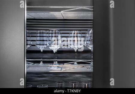 Brandy glasses and wineglasses standing on the shelf. Stock Photo