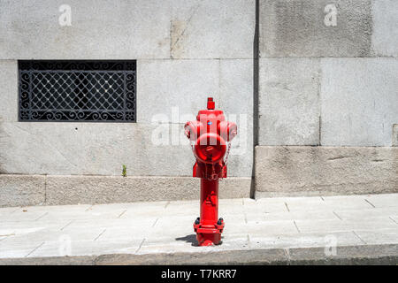 Red fire hydrant in the street. Stock Photo