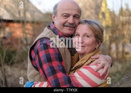 Couple hugging each other walking outdoor at autumn. Stock Photo