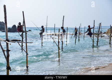 Local fishermen standing in the sea, holding a fishing rod to catch fish,  Lombok Island, Lesser Sunda Islands, Indonesia, Asia Stock Photo - Alamy