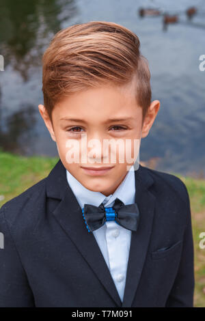 portrait of a boy in a suit in nature Stock Photo