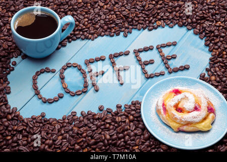 Coffee cup with a cake on a blue wooden background Stock Photo