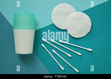 Cotton pads for face and buds for ears, deodorant on blue background. Stock Photo