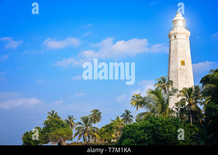 white lighthouse on the shores of the ocean Stock Photo