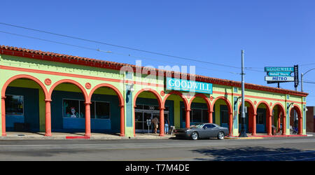 A colorful old building in a Spanish design with a portal walkway houses the Goodwill Store on historic 4th Avenue in downtown Tucson, AZ Stock Photo