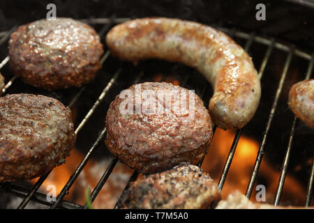 Delicious cooked patties on barbecue grill Stock Photo
