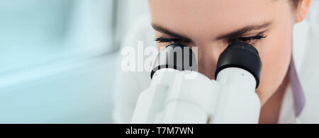 Scientist using microscope in lab, close-up. Laboratory technician while work Stock Photo