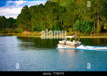 Orlando, Florida. April 02, 2019.  Bay boat at blue lake on green forest background at Walt Disney World  (2) Stock Photo