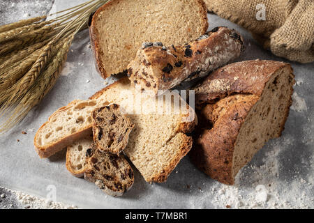 Assortment of baked bread on wooden table background Stock Photo