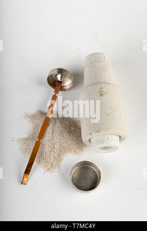 Old ceramic electric fuse. Blown and badly repaired security for energy, Bright background. Stock Photo