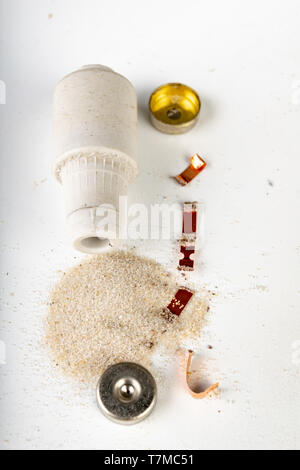 Old ceramic electric fuse. Blown and badly repaired security for energy, Bright background. Stock Photo