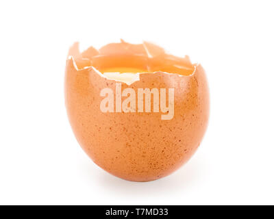 Broken brown egg isolated on white with clipping path. Selective focus on the yolk Stock Photo