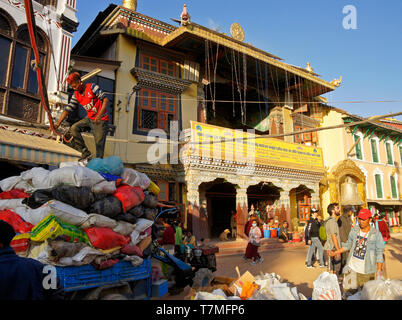 Rubbish collectors in front of Tibetan Buddhist monastery at Boudhanath, Kathmandu Valley, Nepal Stock Photo