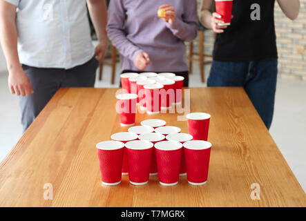 People playing beer pong in bar Stock Photo