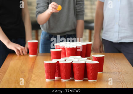 People playing beer pong in bar Stock Photo