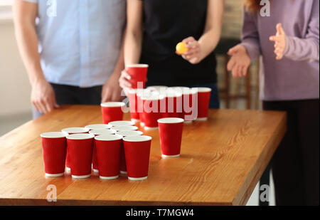 People playing beer pong in bar Stock Photo