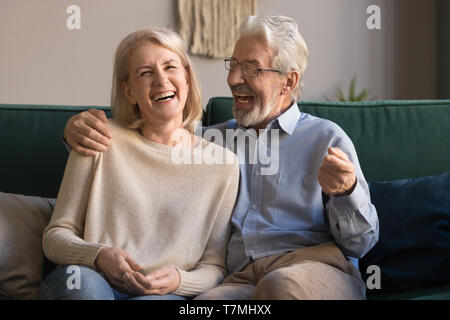 Portrait of middle aged laughing man and woman at home