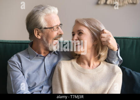 Smiling loving middle aged man and woman enjoying romantic moment Stock Photo