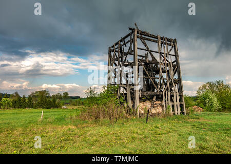 remains of old burnt windmill in the field before the rain Stock Photo