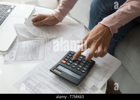 Close up woman hands holding receipt calculating company expenses Stock Photo