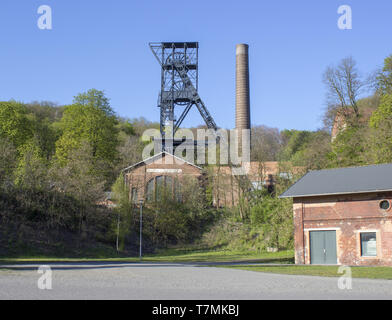 The mine tower for black coal mining Landek in city Ostrava in the Czech Republic. In the background is blue sky with white clouds. In foreground are  Stock Photo