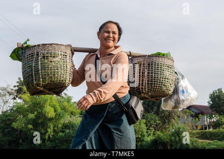 A woman crossing a bridge in Luang Namtha, Laos Stock Photo