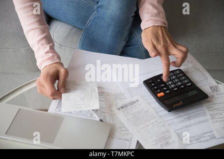 Closeup woman hands using calculator cost money manage family budget Stock Photo