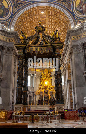The altar with Bernini's baldacchino. Interior of The Papal Basilica of St. Peter in the Vatican, or simply St. Peter's Basilica, Rome, Italy