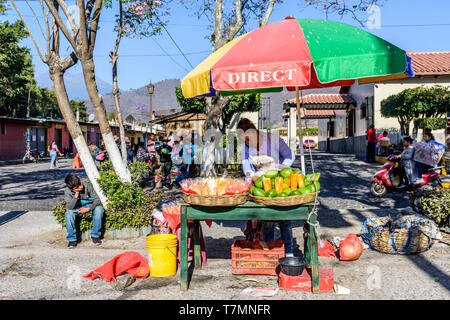 Antigua, Guatemala - April 14, 2019: Street stall selling mango & other fresh fruit on Palm Sunday in UNESCO World Heritage Site. Stock Photo
