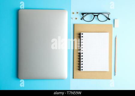 Flat lay composition with office accessories on two tone background, space for text Stock Photo