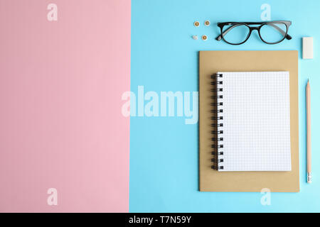 Flat lay composition with office accessories on two tone background, space for text Stock Photo