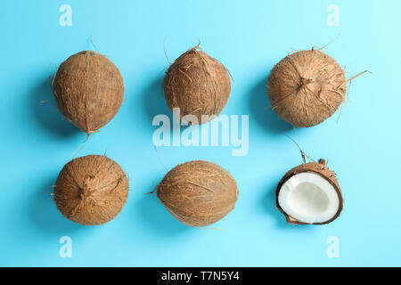 Flat lay composition with coconuts on color background Stock Photo