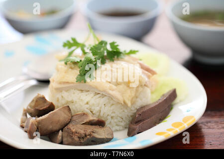 Thai food gourmet steamed chicken with rice , khao mun kai in wood background Stock Photo