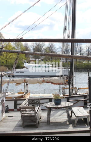 Old sail boat and modern yacht in the dock side by side Stock Photo