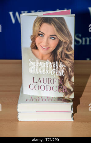 Book by Lauren Goodger 'Secrets of an Essex Girl' in Southend on Sea, Essex, UK. TOWIE, The Only Way Is Essex actress. Stack of books Stock Photo