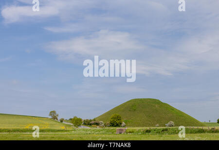 Silbury Hill is a prehistoric artificial chalk mound near Avebury in the English county of Wiltshire. Stock Photo